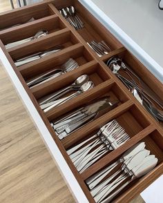 an open drawer with silverware in it