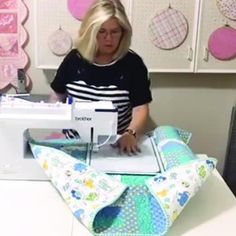 a woman is using a sewing machine to sew