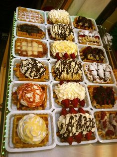 a table topped with lots of different types of waffles covered in toppings