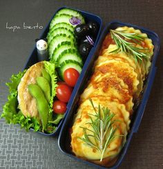 two blue trays filled with food on top of a table