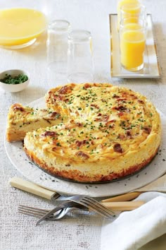 a quiche on a plate with two slices cut out and ready to be eaten