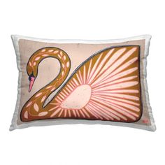 a decorative pillow with a pink and orange swan on it's side, in the shape of a sunburst