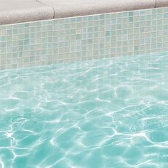 an empty swimming pool with clear blue water