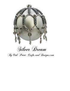 a white ornament with silver beads on it's side and the words sister dream