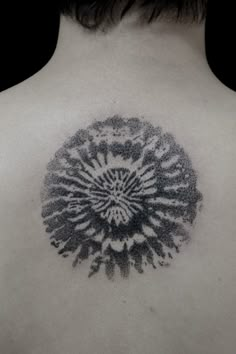 the back of a person's neck with a tattoo on it