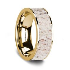 a wedding ring with an animal's eye in yellow gold and white antelope