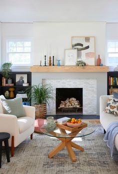 a living room filled with furniture and a fire place in the middle of a room