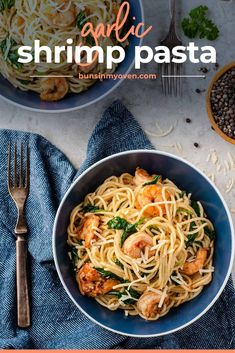 shrimp pasta with spinach and parmesan in a blue bowl next to a fork