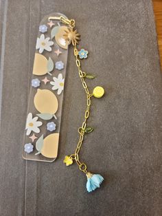 a cell phone chain with charms attached to it