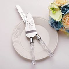 two forks and knife on a plate with flowers in the background