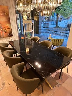 a dining room table with chairs and a chandelier