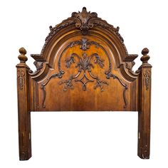 a wooden headboard with ornate carvings on the top and bottom panel, in an antique style