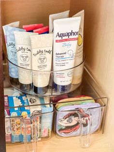 an open cabinet containing various items such as toothpaste, lotion and hand sanitizers