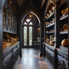 an old fashioned kitchen with wooden cabinets and stained glass windows in the center, along with stone flooring