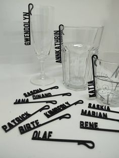 black and white photo of various glassware with names on them