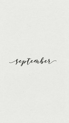 the word september written in cursive ink on a white paper with black writing