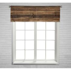 a white brick wall with a window and wooden blinds