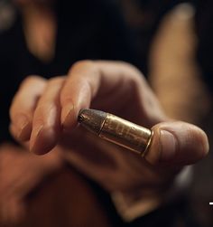 a close up of a person holding a cell phone in their hand with the other hand