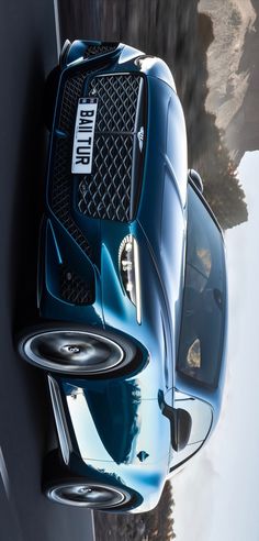 the front end of a blue sports car