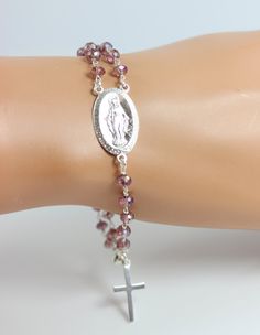 "This is a stunning rosary inspired bracelet made with 4mm Amethyst color crystals on Sterling Silver. A large 1\" Sterling Silver Miraculous medallion and 3/4\" Sterling Silver cross pendant make this rosary bracelet stand out! Bracelet may be ordered in a 6.5-9.5\" length. Priced accordingly, you choose size. Comes nicely boxed, the perfect gift! Also comes in 14kt Gold Filled, see last picture. This Miraculous Medallion is larger then other rosary bracelets. Ships in 5-7 business days. I do o 14kt Gold Jewelry, Rosary Jewelry, Bracelet Stand, Catholic Jewelry, Sterling Silver Cross Pendant, Rosary Bracelet, Silver Cross Pendant, Jewelry Design Necklace, Sterling Silver Cross