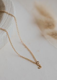 Is there anything sweeter than a tiny single initial? We don’t think so! 8 x 6mm uppercase block letter is suspended from delicate cable or scout chain. Offered in 16" or 18" lengths. Available in 14kt Gold Fill + Sterling Silver. Kayla layers it with our Pearl Linked Necklace. Handmade in Eau Claire, WI. Our jewelry is handmade so each piece will be unique and may vary slightly from what is pictured. Initial Pendant Necklace With Cable Chain, Simple Initial Pendant Necklace With Delicate Chain, Delicate Chain Initial Pendant Necklace, 14k Gold Initial Necklace With Cable Chain For Everyday, Gold Initial Necklace With Cable Chain, Initial Pendant Charm Necklace With Cable Chain, Simple 14k Gold Initial Pendant Charm Necklaces, Everyday Name Necklace With Initial Pendant, Simple 14k Gold Initial Pendant Necklace