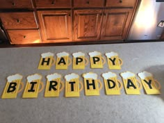 happy birthday cutouts with beer mugs on the counter in front of a refrigerator