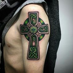 a man with a cross tattoo on his arm