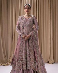 a woman in a pink and gold wedding gown