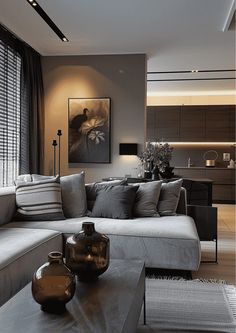 a living room filled with lots of furniture next to a large window covered in blinds