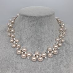 Vintage ANNE KLEIN pearl choker necklace. Silver-tone metal with beige faux pearl and clear rhinestone collar. Statement choker for the wedding. Necklace length: 34-42 cm/13-16 inches. Mark- Anne Klein. Condition- good vintage, but there are scratches on the pearl beads. Maybe you want to see other necklaces too: https://www.etsy.com/shop/VintageVoyageLT?ref=seller-platform-mcnav&section_id=32072411 You can write me a message if you have any questions. Glad you visited my store! Have a great tim Silver Pearl Drop Choker For Wedding, Wedding Silver Choker With Pearl Drop, Formal Beaded Pearl Rhinestone Necklace, White Rhinestone Choker For Wedding, Silver Pearl Chain Bridal Choker Necklace, Silver Bridal Choker With Pearl Chain, Silver Pearl Chain Bridal Choker, Beaded Rhinestone Choker For Wedding, Silver Pearl Rhinestone Necklace For Formal Occasions