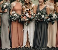 a group of women standing next to each other wearing dresses and holding bouquets in their hands