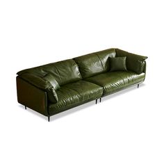 a green leather couch sitting on top of a white floor