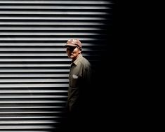 a man standing in front of a metal wall