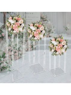 three vases with flowers in them sitting on a table