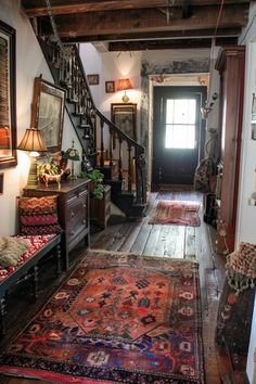 the hallway is decorated with antique rugs and antiques