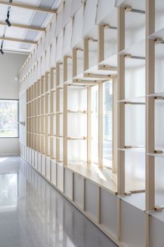 an empty room with shelves and windows in the wall, all lined up against each other