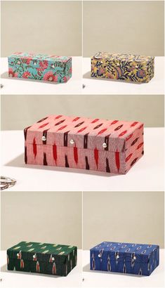 four different boxes with designs on them sitting next to each other, all in different colors