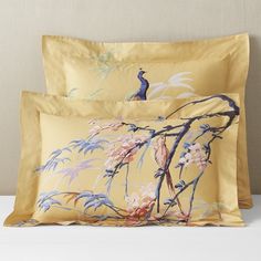 two pillows with birds and flowers on them