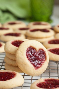 heart shaped cookies with jelly filling on cooling rack