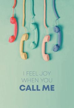 four telephones hanging from the side of a wall with text that reads, i feel joy when you call me