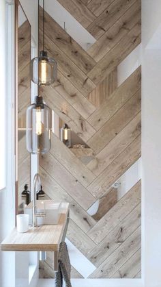 a bathroom with wooden walls and flooring next to a sink in front of a mirror