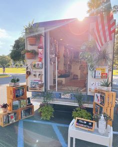 the back of a truck with plants and pictures on it