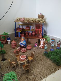 an assortment of clay pots and figurines in a playroom setting with toys