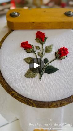 a close up of a piece of cloth with flowers on it and a wooden frame