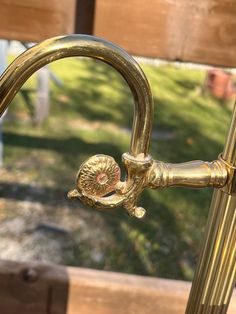 an old fashioned brass faucet in front of a wooden bench