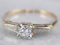 an antique diamond ring with two tone gold band