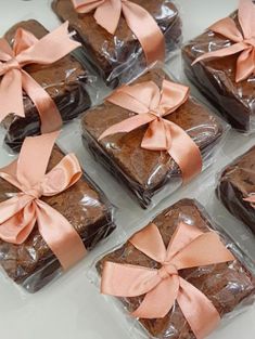 six brownies wrapped in plastic with pink bows