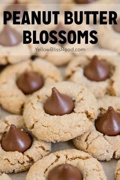 peanut butter blossoms with chocolate in the middle on a baking sheet and text overlay