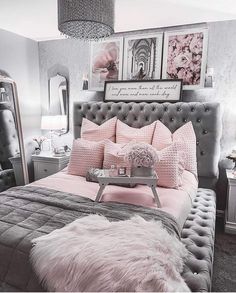 a bedroom with pink and gray decor in the corner, including a tufted bed