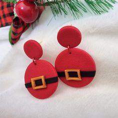 The Santa Belt Clay Earring, with its red stud dangle design, makes for a charming addition to any festive outfit. As a stocking stuffer for a roommate, this cute Christmas holiday jewelry captures the minimalist festival spirit perfectly. 🎁 Gift wrapping option available at checkout ✨️ Polymer clay = lightweight for all-day comfort.  ✨️ Stainless steel hardware. ✨️ Preorder ships in 3-5 days. ✨️ Slight variations may occur as they are handmade. 🎁 Elegant gift wrapping paper featuring a femini Santa Belt, Santa Belts, Elegant Gift Wrapping, Roommate Gifts, Red Studs, Jewelry Minimalist, Clay Earring, Holiday Jewelry, Feminine Design